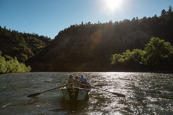 Guide rows fishing boat on the Rogue River